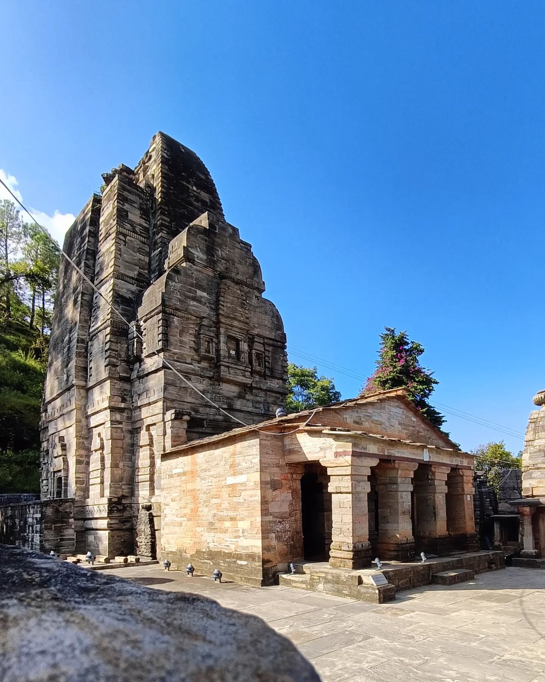 Katarmal Sun Temple with intricate carvings and Himalayan backdrop